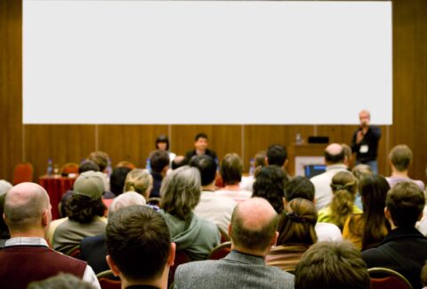 conference hall full of people participating